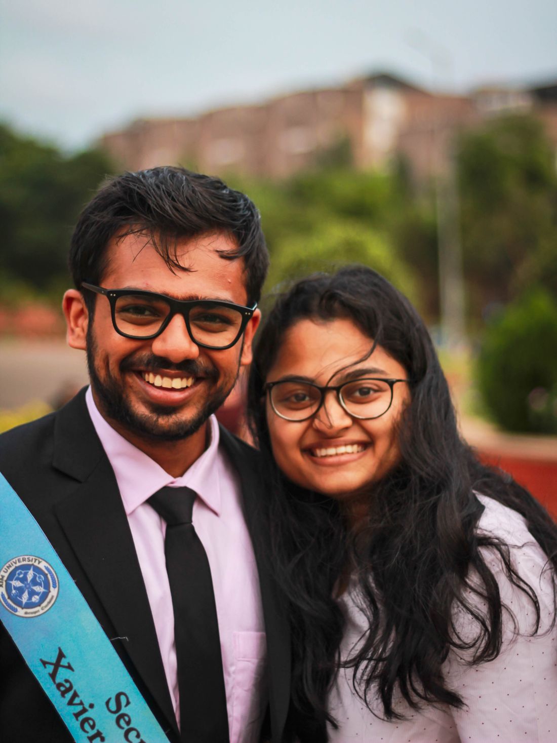 Two graduating students on a college campus in India